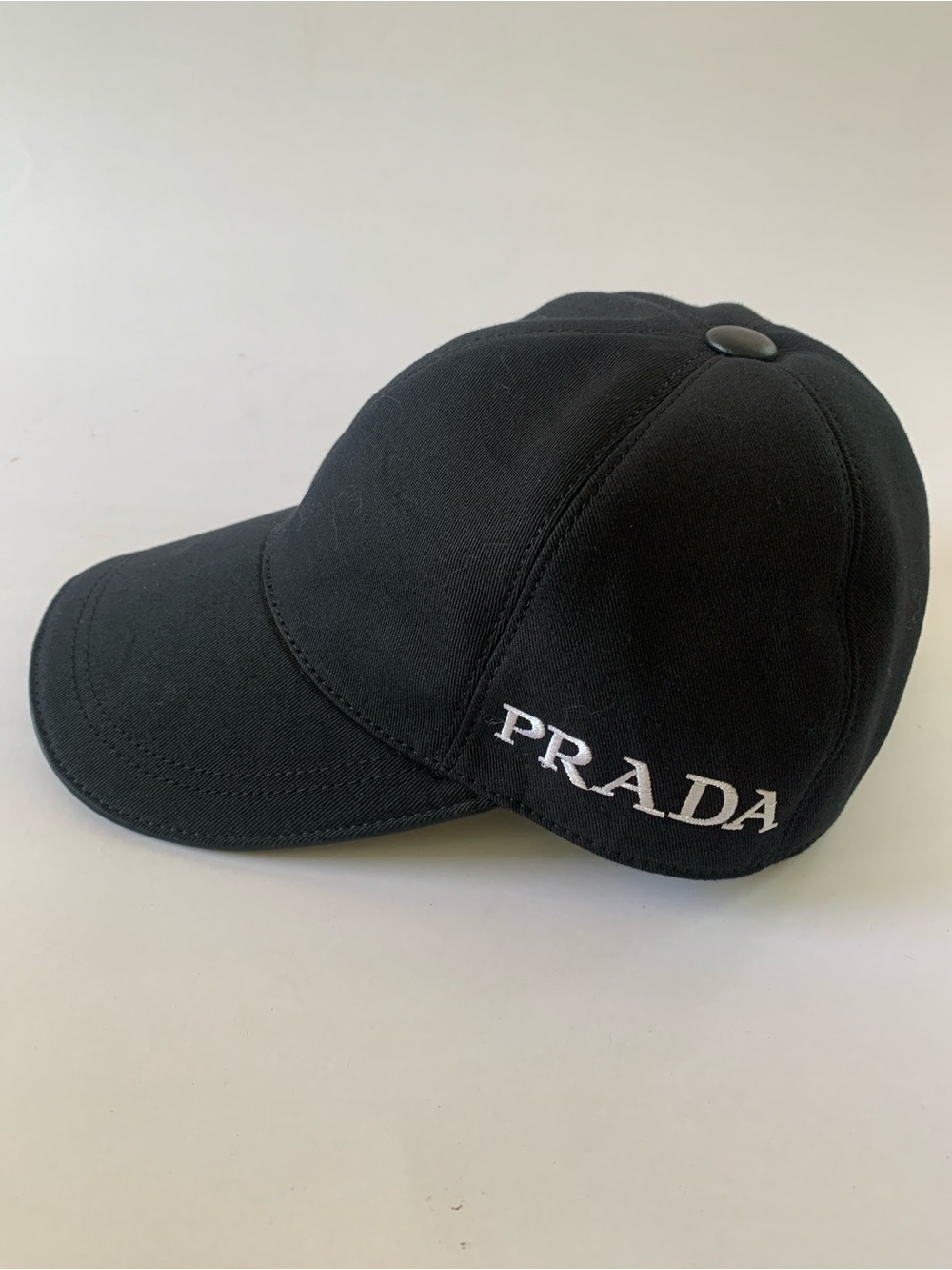 Authentic Prada Black Cap with White Embroidered Logo and leather accents